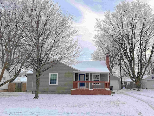 view of front facade featuring a garage and an outbuilding