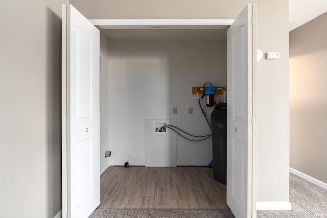 clothes washing area with hookup for a washing machine and light hardwood / wood-style floors