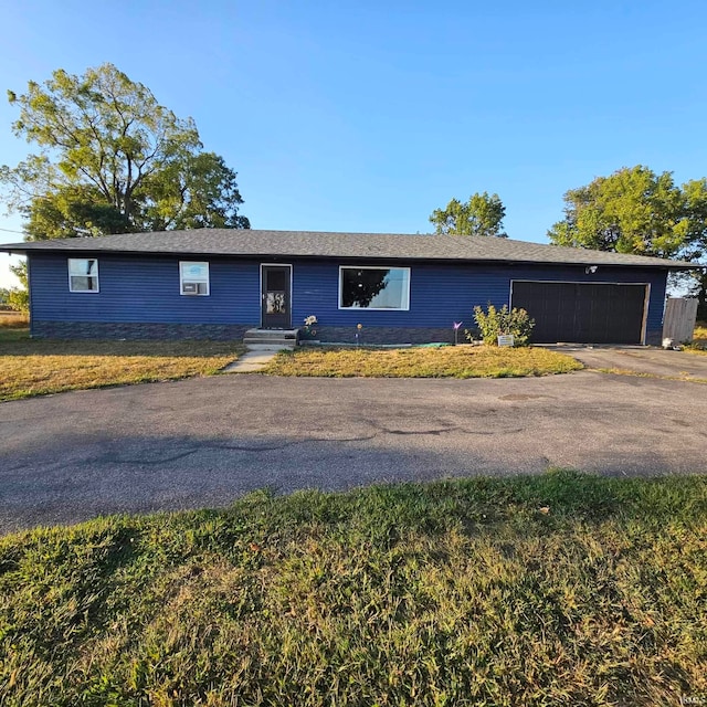 single story home with a garage and a front yard