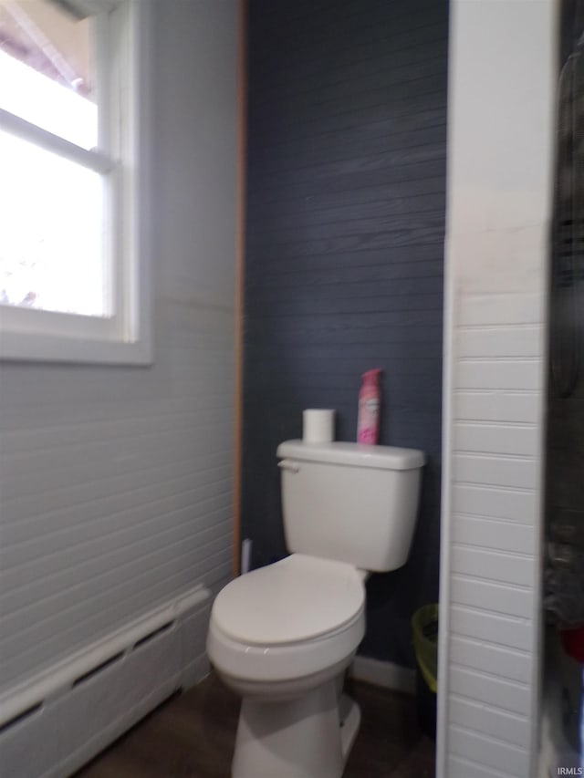 bathroom with toilet and a baseboard heating unit