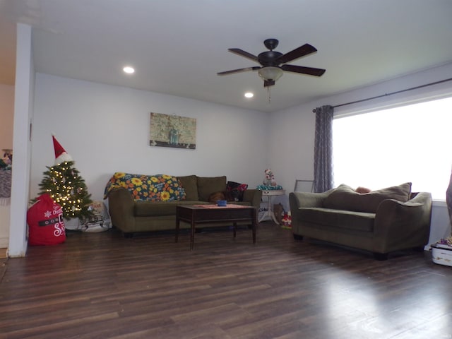 living room featuring dark hardwood / wood-style floors and ceiling fan