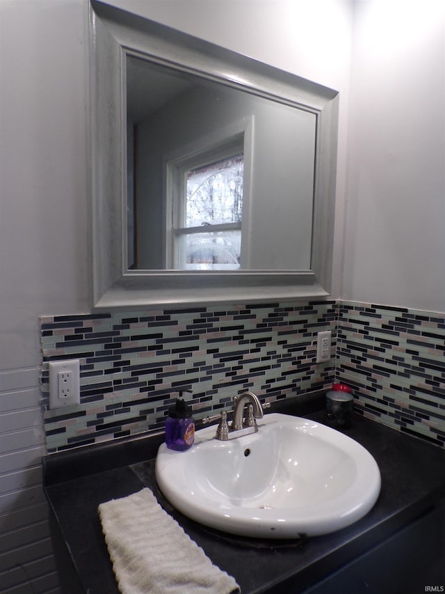 bathroom featuring sink and tasteful backsplash