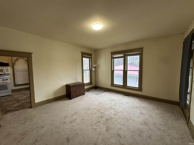 unfurnished room with light carpet