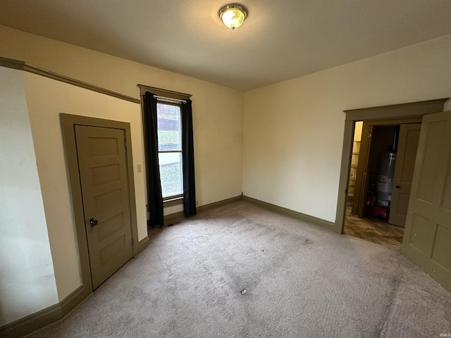 carpeted spare room with gas water heater