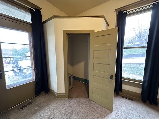 unfurnished bedroom with carpet and multiple windows