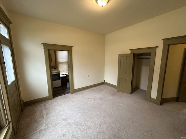 unfurnished bedroom featuring light colored carpet