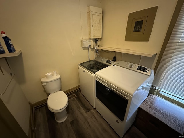 washroom featuring electric panel, dark hardwood / wood-style floors, and independent washer and dryer