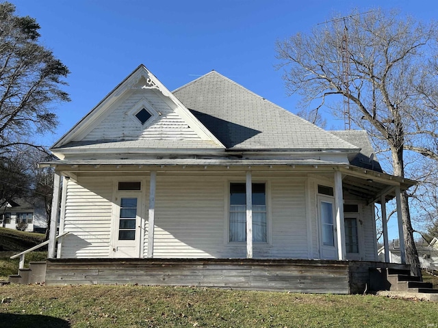 rear view of house featuring covered porch