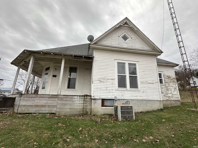 view of home's exterior featuring a yard and central AC unit