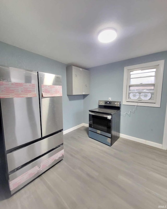 kitchen featuring light wood-type flooring and appliances with stainless steel finishes