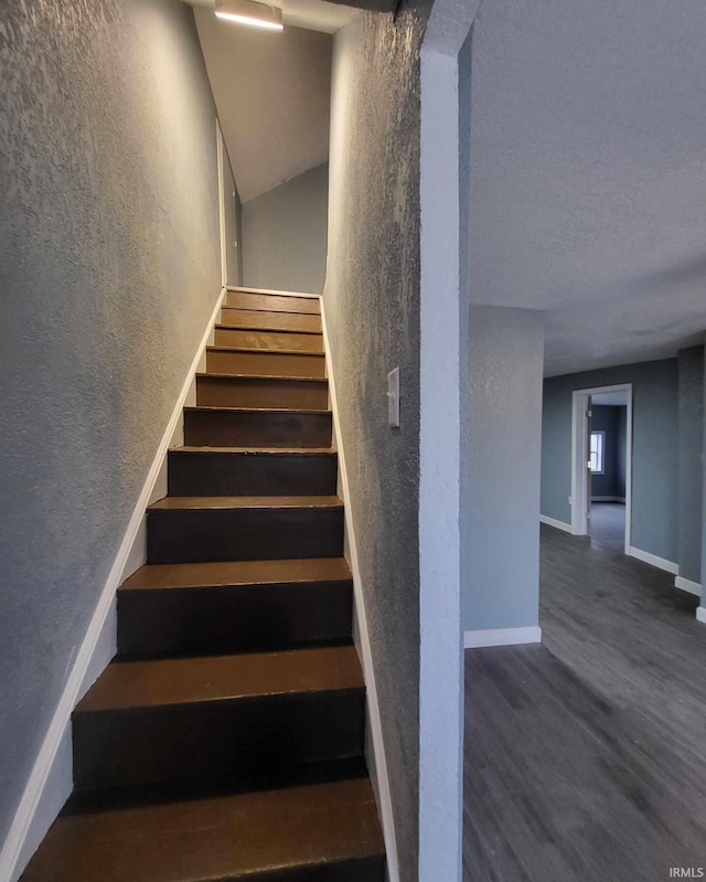 stairway featuring wood-type flooring