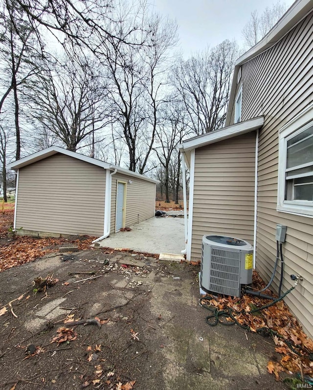 exterior space with central air condition unit and an outdoor structure