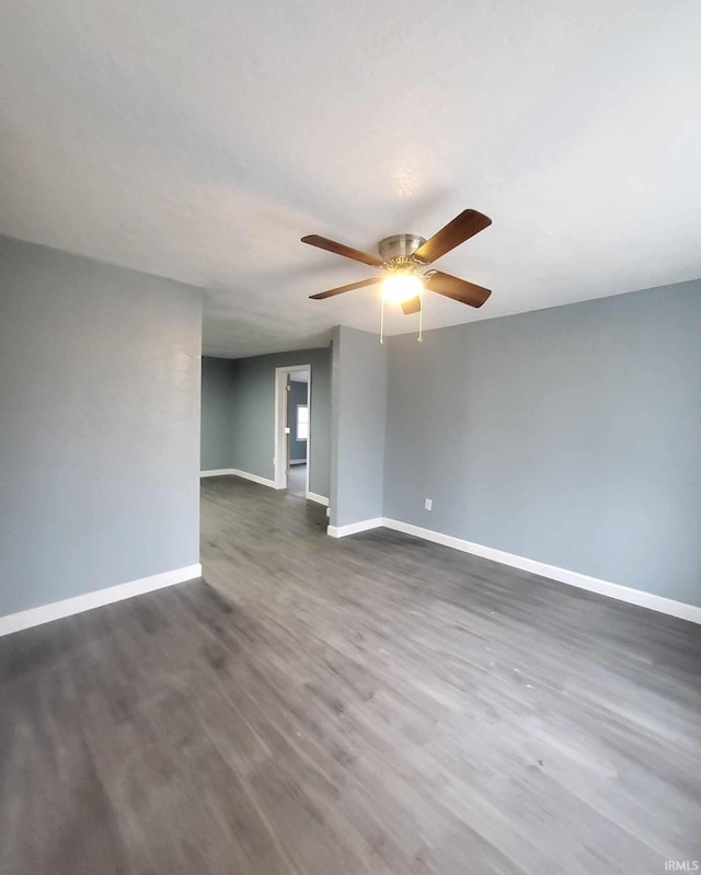 unfurnished room with dark hardwood / wood-style flooring and ceiling fan