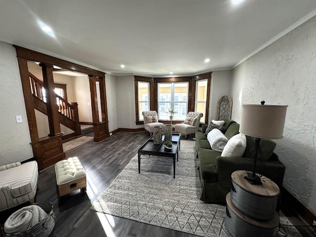 living room with wood-type flooring, crown molding, and ornate columns