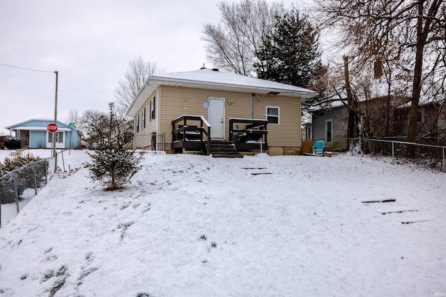 view of snow covered rear of property