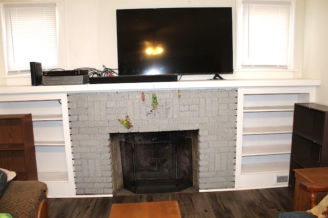 room details featuring a fireplace and wood-type flooring