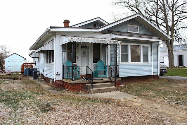 bungalow-style home featuring central AC unit