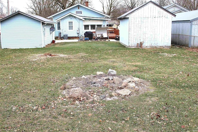 view of yard with central AC unit and a shed