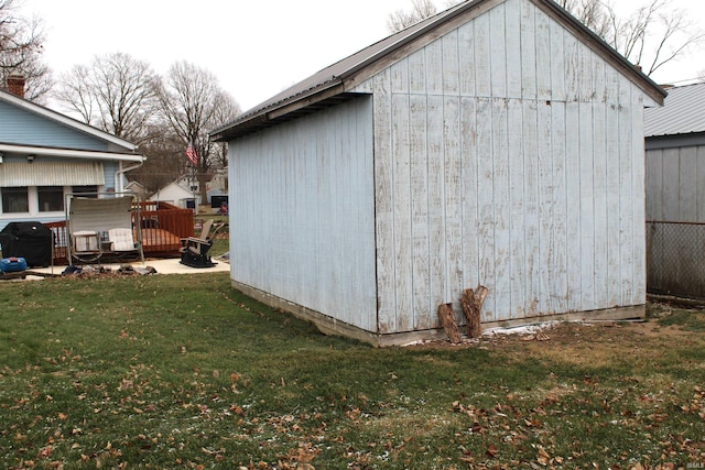 view of outbuilding featuring a yard