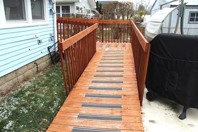 wooden terrace featuring a grill