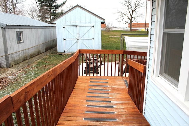 wooden deck featuring a yard and a shed