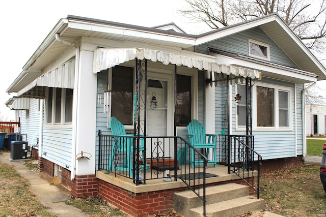 bungalow-style house with central AC unit