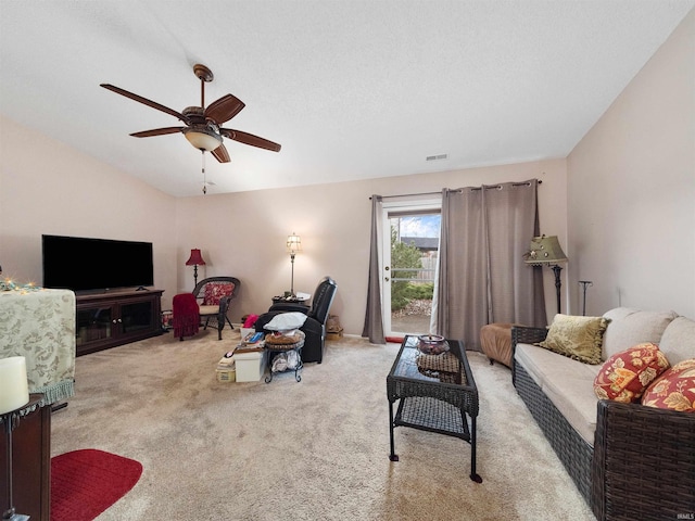 living room featuring light colored carpet, vaulted ceiling, and ceiling fan