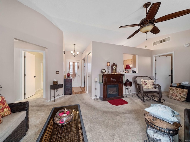 living room featuring ceiling fan with notable chandelier, light colored carpet, and vaulted ceiling