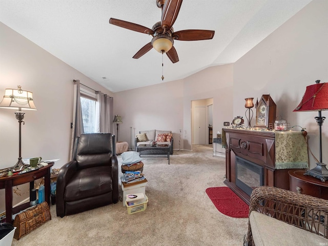 carpeted living room featuring ceiling fan and vaulted ceiling