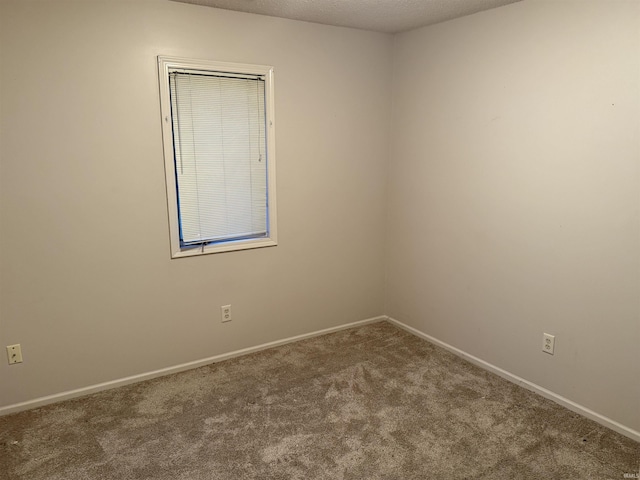 carpeted spare room with a textured ceiling