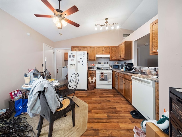 kitchen featuring lofted ceiling, white appliances, sink, dark hardwood / wood-style floors, and washer / clothes dryer