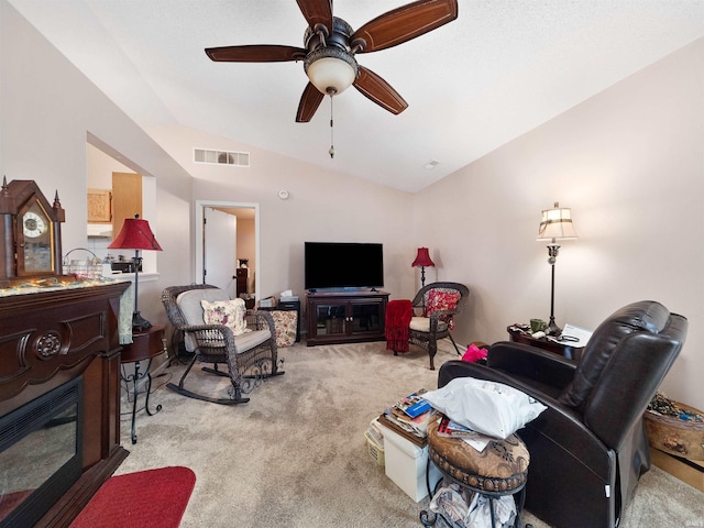 carpeted living room featuring ceiling fan and lofted ceiling