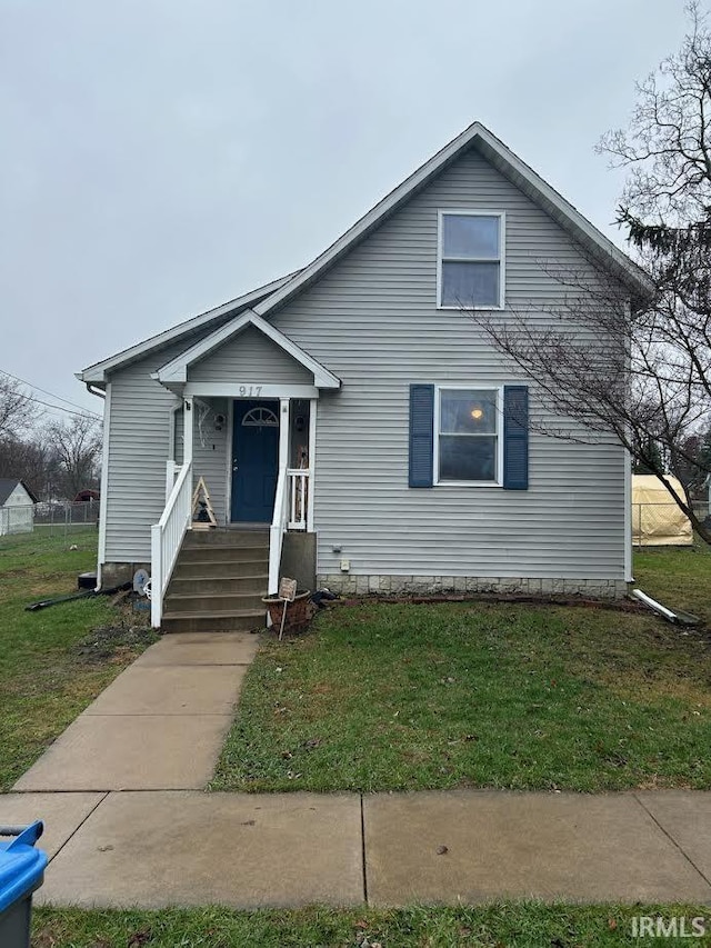 bungalow-style home with a front yard