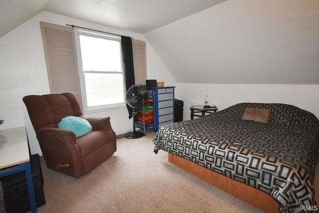 carpeted bedroom with lofted ceiling