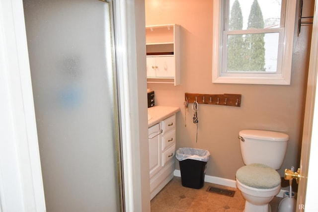 bathroom featuring walk in shower, tile patterned flooring, vanity, and toilet