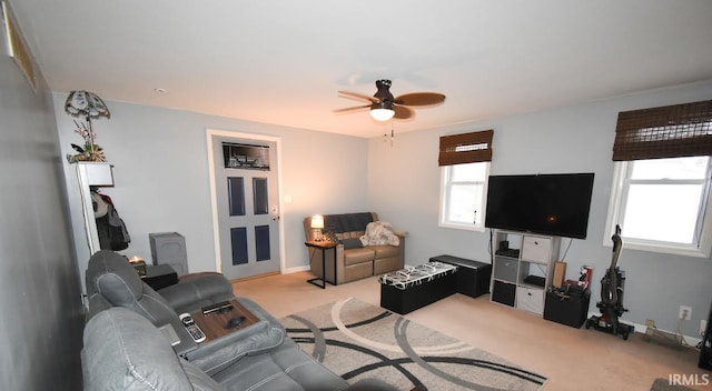 carpeted living room featuring ceiling fan