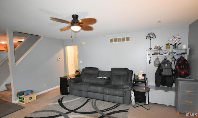 carpeted living room with ceiling fan