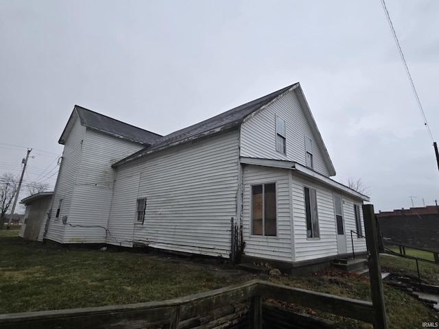 view of side of home with a lawn