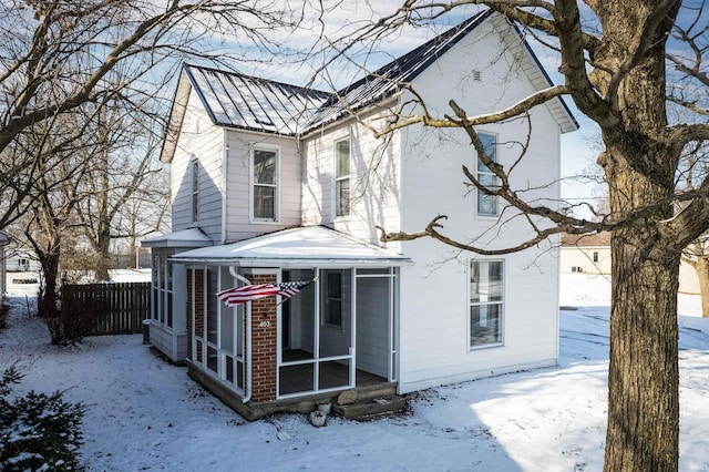 view of front of home with a sunroom