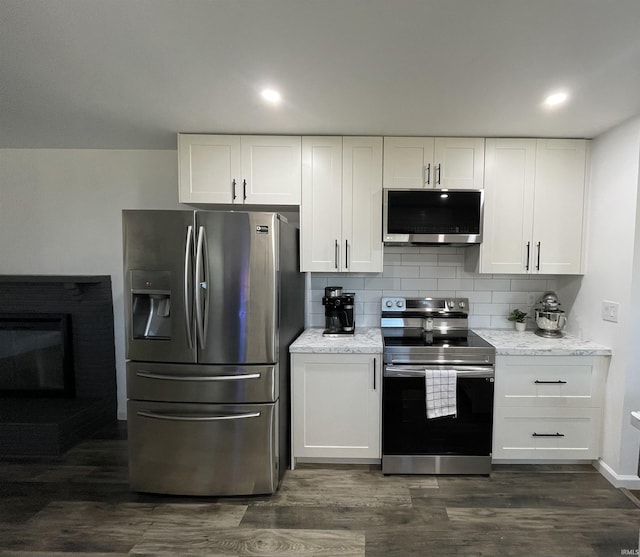 kitchen featuring white cabinets, stainless steel appliances, and dark hardwood / wood-style floors