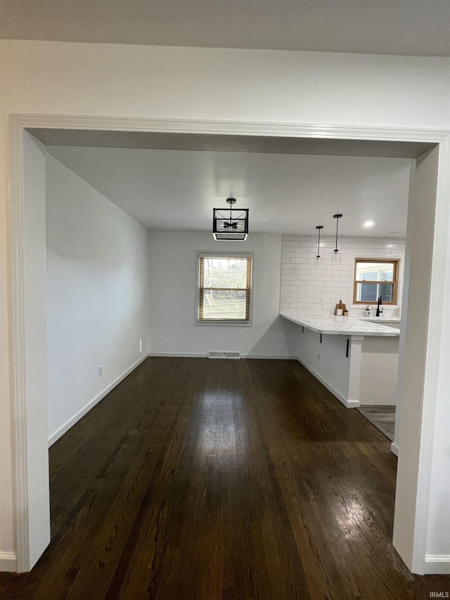 unfurnished dining area featuring dark hardwood / wood-style floors