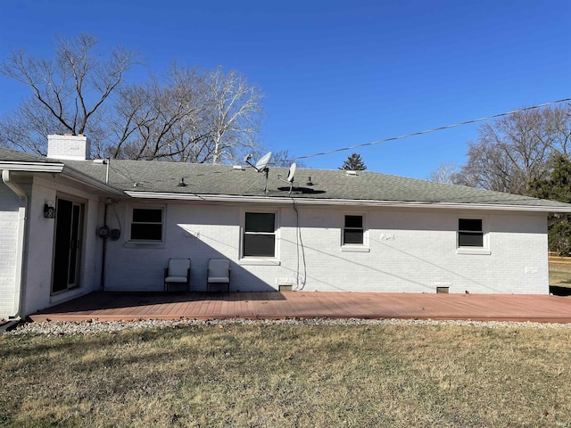 back of house featuring a wooden deck and a yard