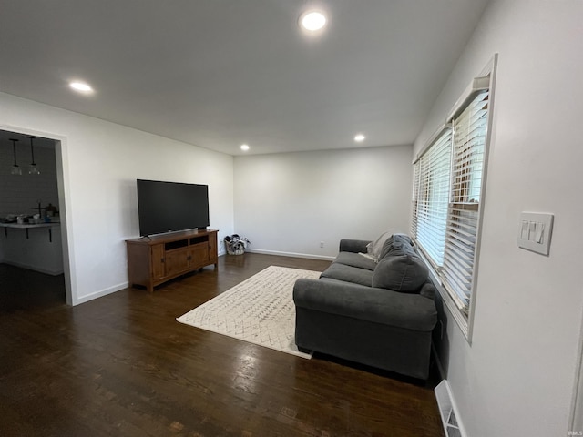 living room with dark hardwood / wood-style flooring