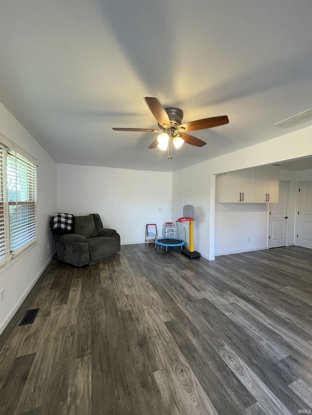 unfurnished room with ceiling fan and dark wood-type flooring