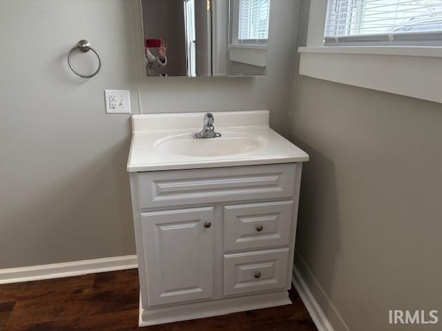 bathroom featuring hardwood / wood-style flooring, vanity, and a wealth of natural light