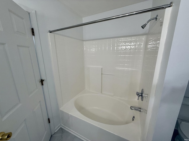 bathroom with toilet and shower / bath combination