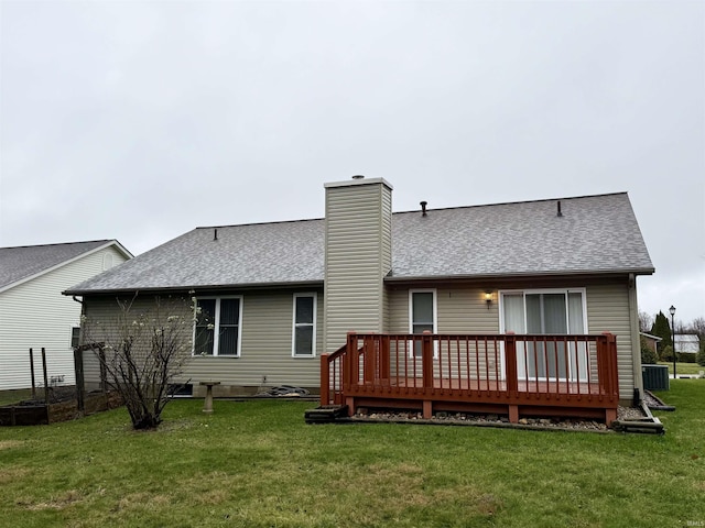 back of property with a lawn, central air condition unit, and a deck