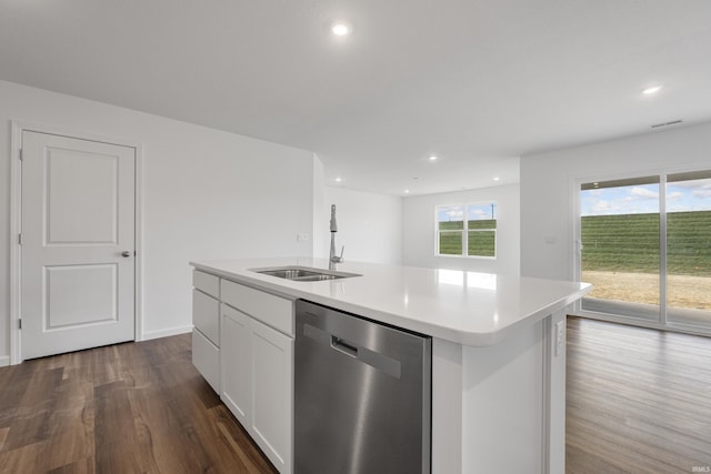 kitchen featuring white cabinets, a kitchen island with sink, sink, dishwasher, and dark hardwood / wood-style floors