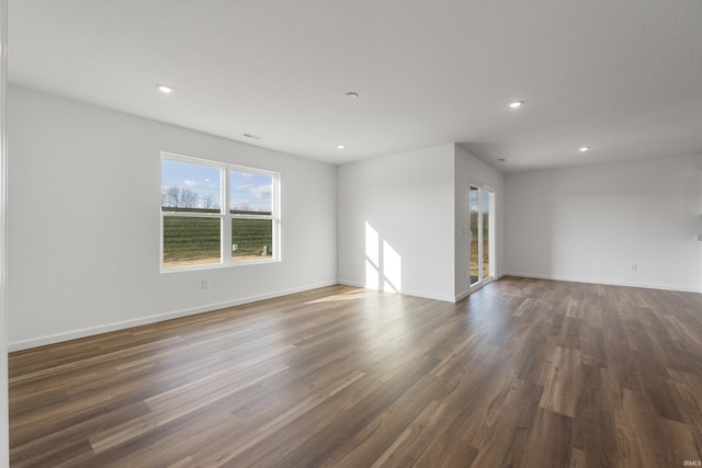 spare room with dark hardwood / wood-style flooring