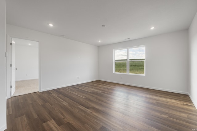 unfurnished room with dark hardwood / wood-style flooring